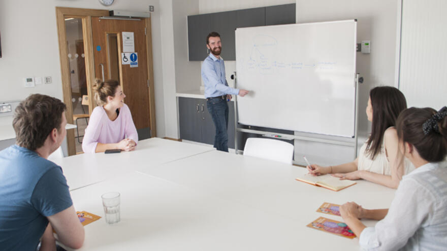 Group of people in office meeting room listening to presentation