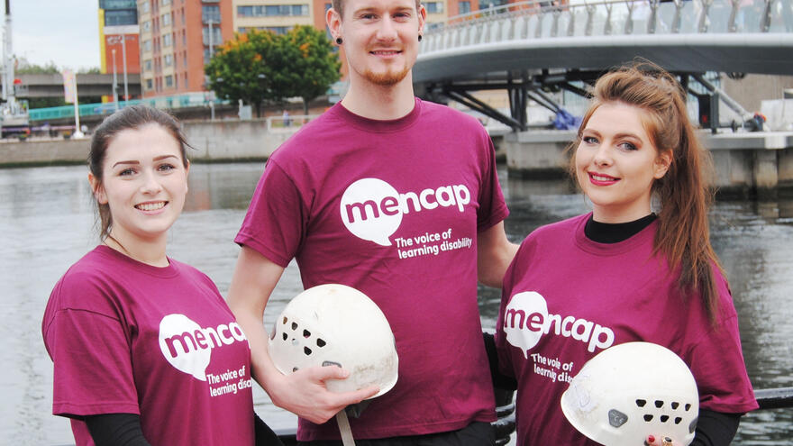 Three people preparing to zipline