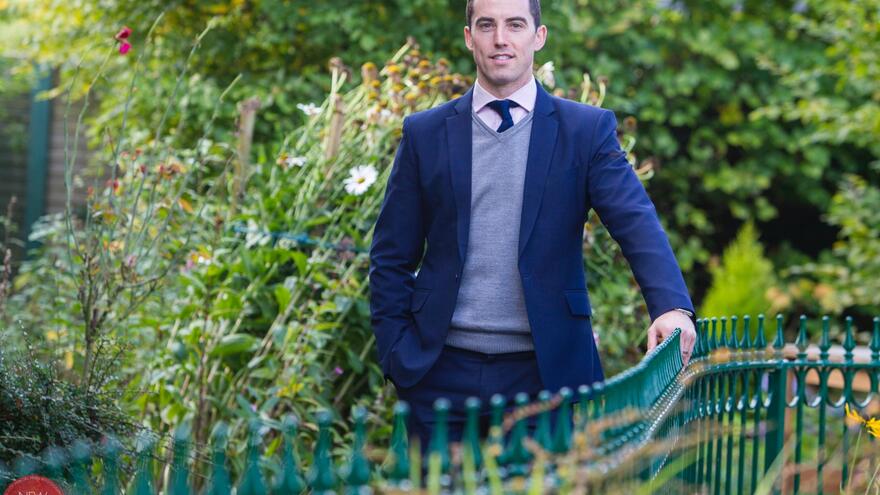 Man wearing a suit stood in a garden