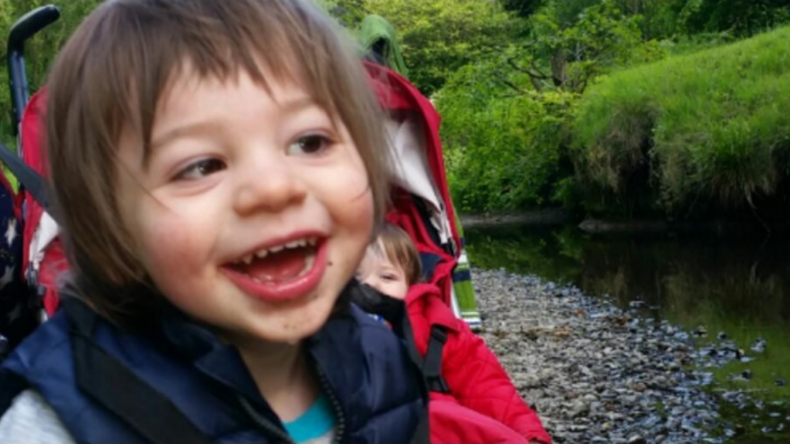 Young boy smiling outside