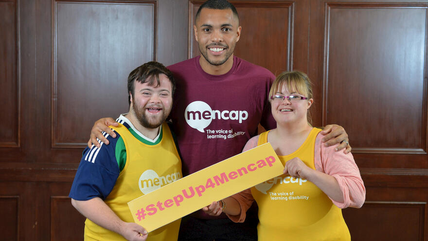 People stood together holding a #StepUp4Mencap sign