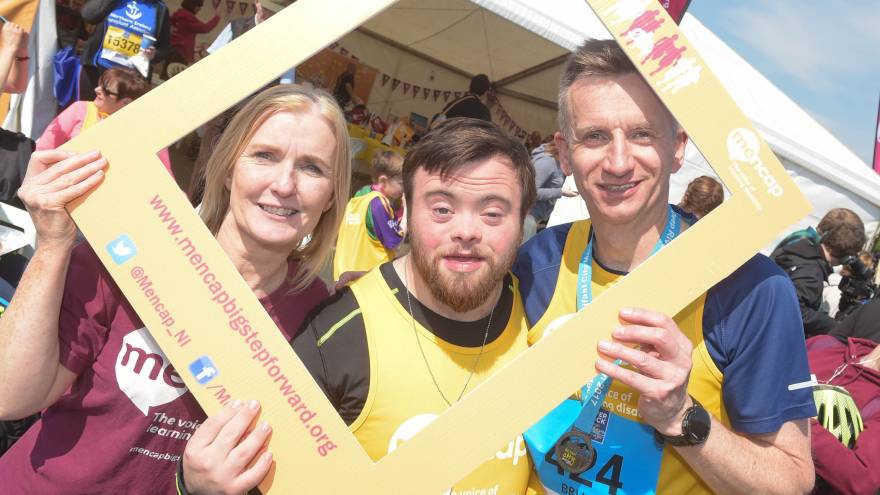 Three people with a #StepUp4Mencap frame over their heads