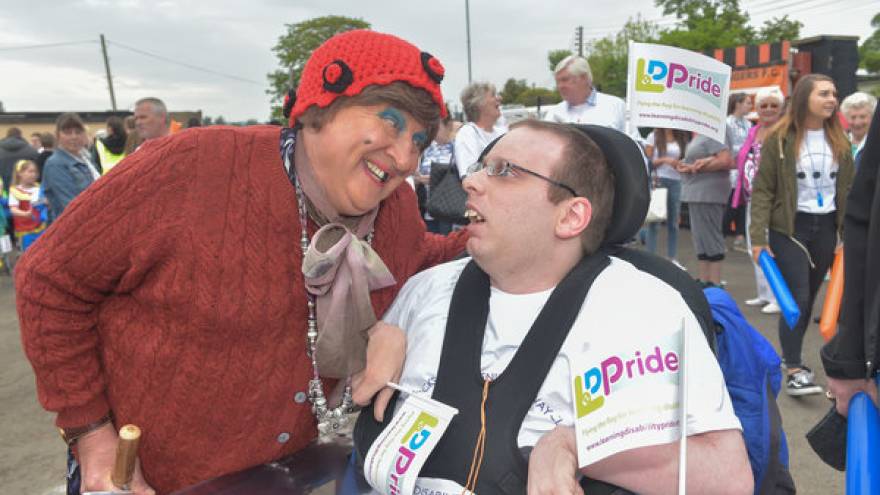 Woman smiling at man in wheelchair