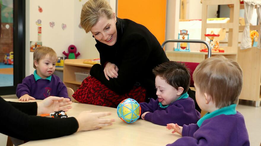 HRH The Countess of Wessex playing with young children at table in Mencap Centre.