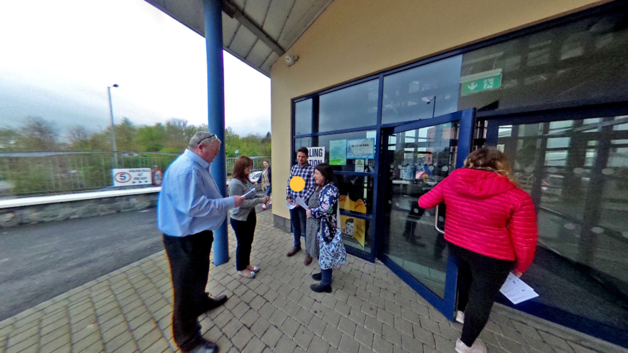 Group of people stood outside a ploiing station
