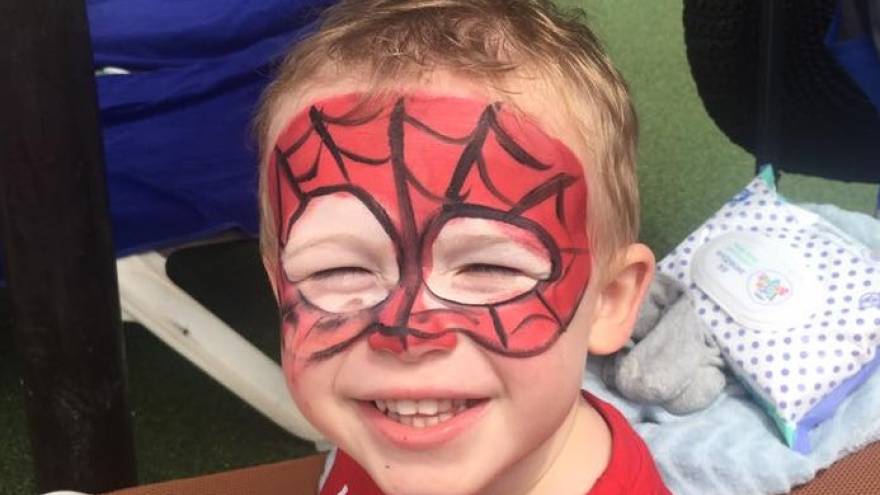 Harley with his face painted as spiderman