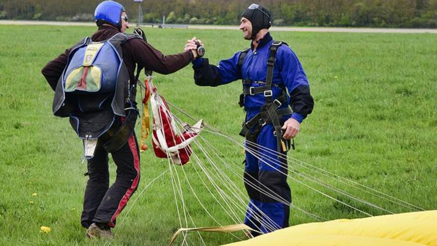Two men who have just completed a skydive celebrating