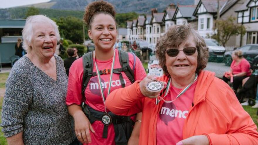 Three people who are fundraising for Mencap doing a mountain walk