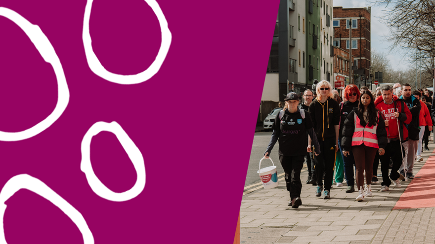 A group of people collecting whilst walking down a street