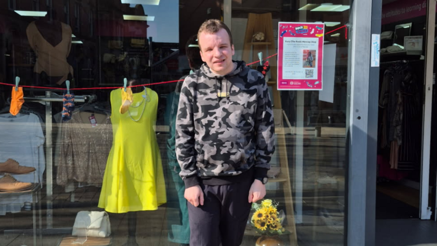 James standing outside the Mencap shop in Bury, The Rock