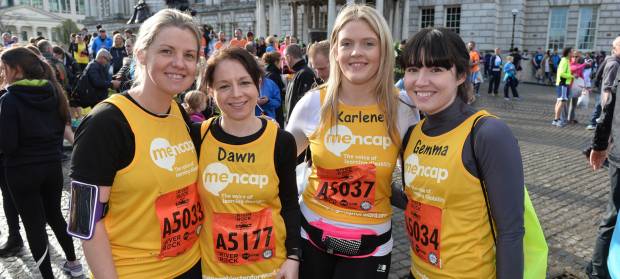 Four woman stood together wearing Mencap running vests.