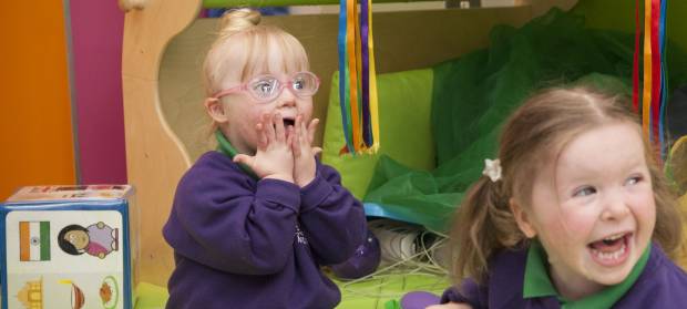 Daisy and Lucy sat together playing at Mencap Centre