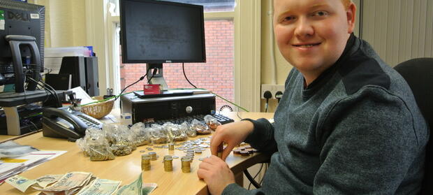 Man sat at a table counting money