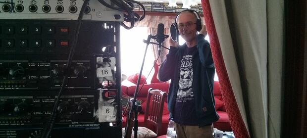 Man stood in recording studio with headphones on