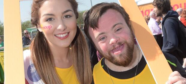 Two people with a #StepUp4Mencap frame over their heads