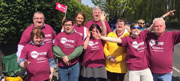 Group of volunteers stood outside together cheering