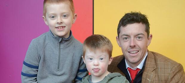 Rory McIlroy stood with two young boys