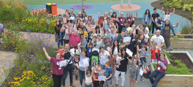 Group of people stood together celebrating outside at Mencap Centre
