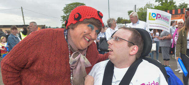 Person smiling at man in wheelchair
