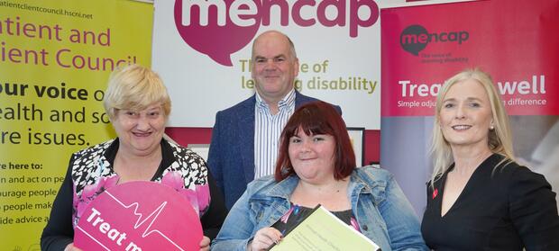 Four people stood together in front of Mencap signs, posing for NI Activism Week 2018