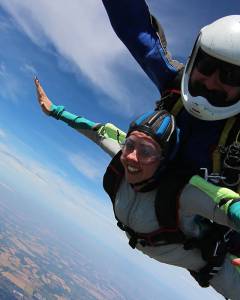 Woman skydiving strapped to a professional 